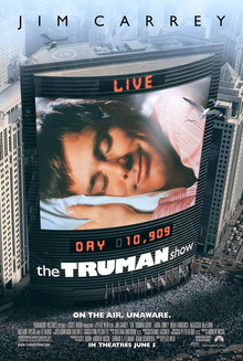main character is sleeping, and this is being broadcast on a screen against a large building